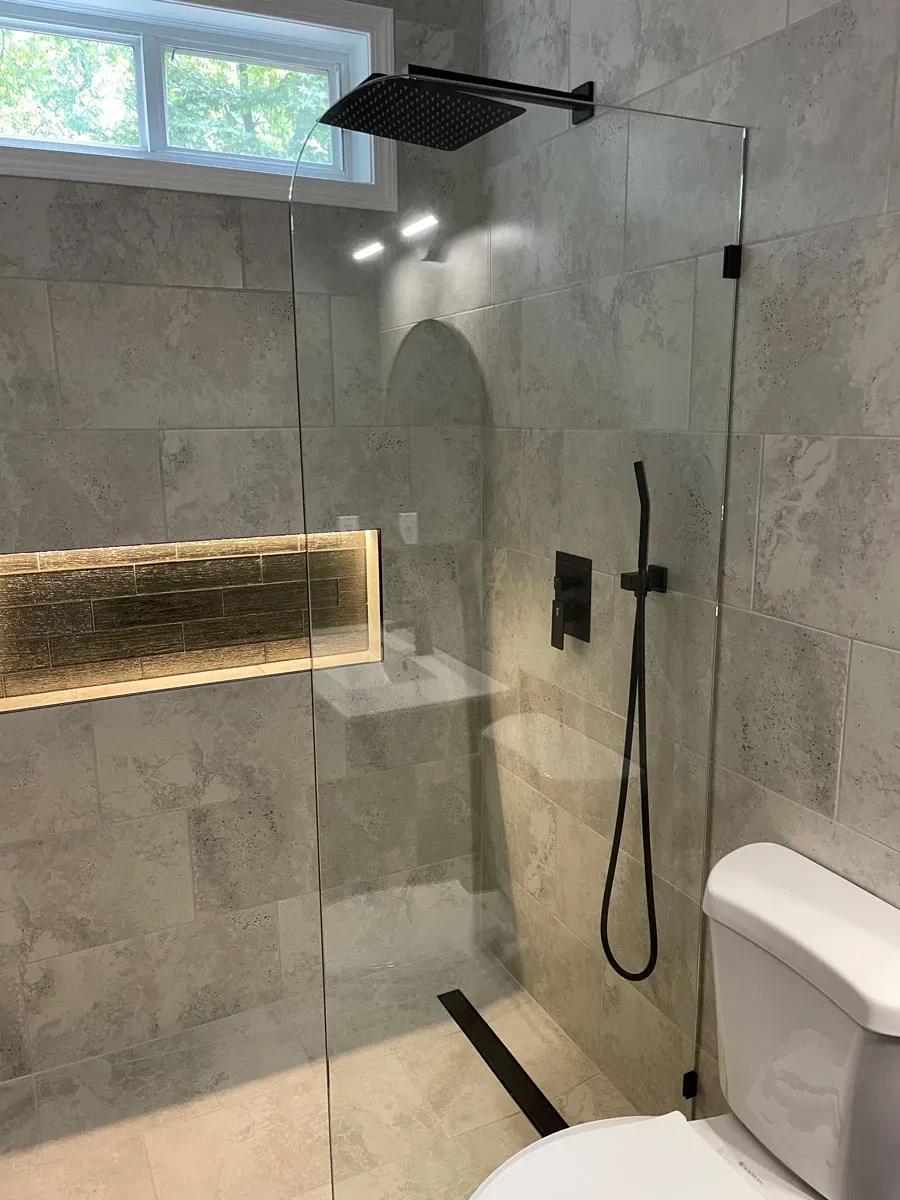 Modern bathroom with glass shower and marble tiles